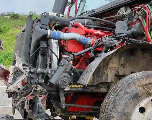 Engine bay of a tractor opened up for a roadside repair.