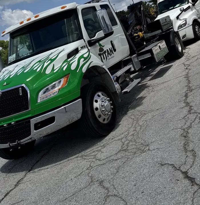 Titan heavy-duty wrecker in green flame livery.